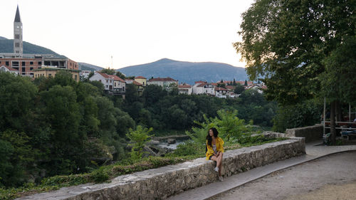 Woman sitting on wall