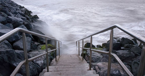 High angle view of staircase by sea