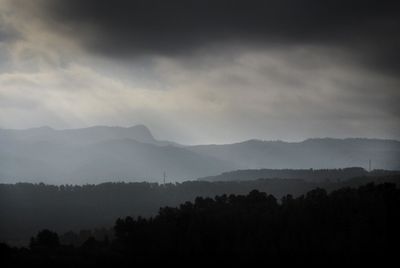 Scenic view of silhouette mountains against sky