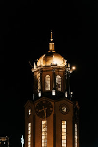 Low angle view of illuminated building against sky at night