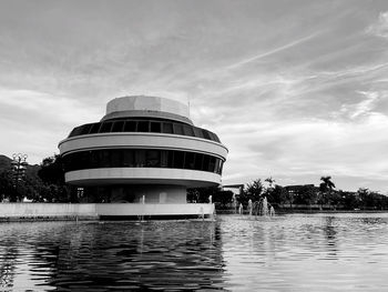 View of swimming pool by building against sky