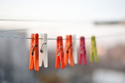 Close-up of clothespins hanging on clothesline