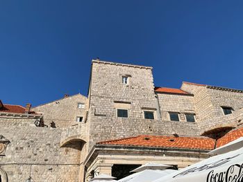 Low angle view of building against blue sky