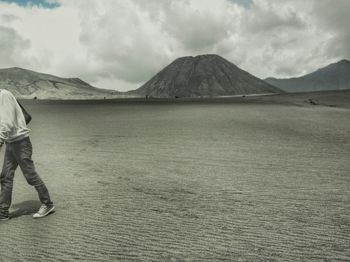 Scenic view of mountains against cloudy sky