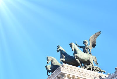 Low angle view of statue against blue sky