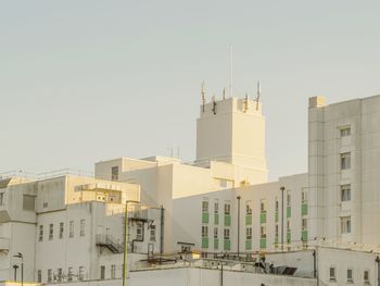 Low angle view of buildings in city against clear sky