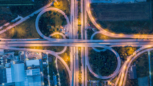 Aerial view of illuminated highways at night