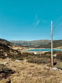 Scenic view of land against blue sky