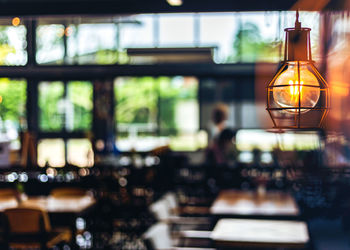 Close-up of illuminated light bulb on table