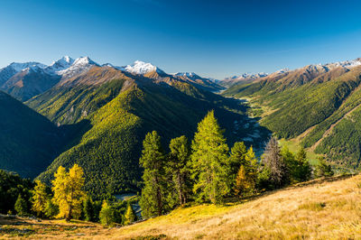 Scenic view of mountains against blue sky