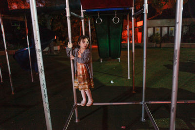 Full length of woman standing on slide at playground