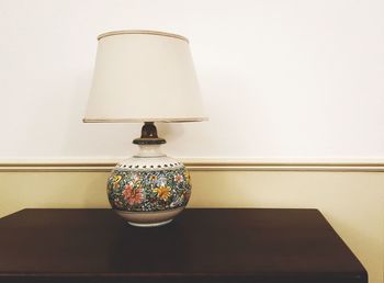 Close-up of illuminated lamp on table at home