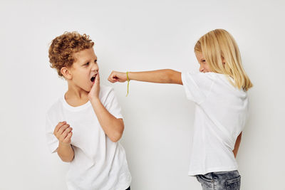 Sibling fighting against white background