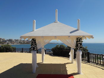 Built structure on beach against clear sky