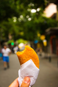 Close-up of hand holding a empanada