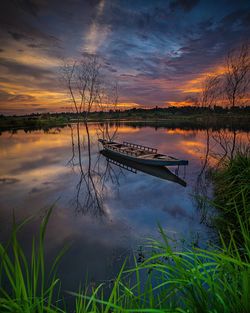 Scenic view of lake against sky at sunset