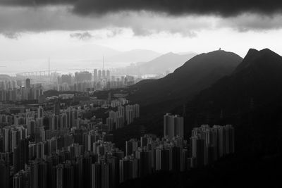 Silhouette buildings in city against sky