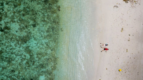 Directly above shot of people lying at beach