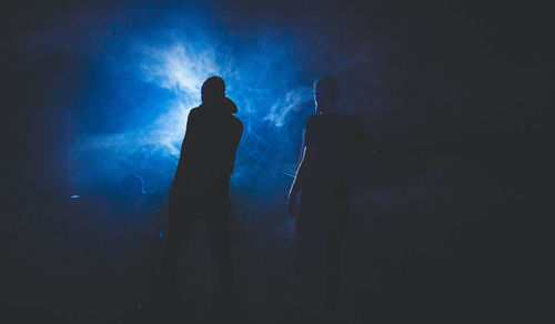 Low angle view of silhouette people at night