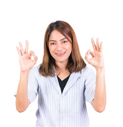 Portrait of a smiling young woman against white background