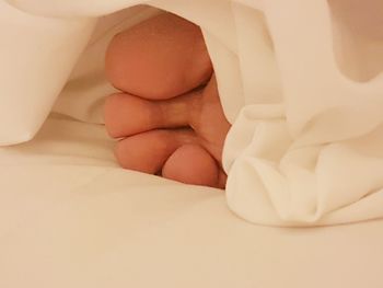 Close-up of baby lying down on bed