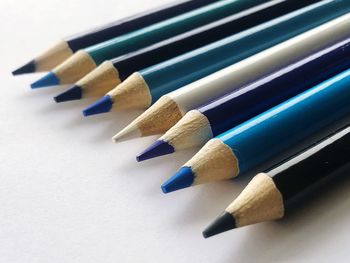 High angle view of colored pencils on white background