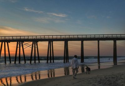 Pier on sea at sunset