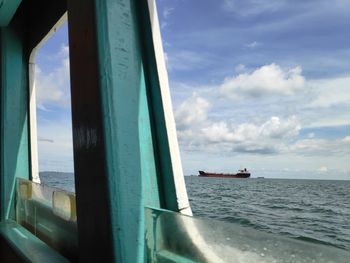 Boat sailing in sea against sky