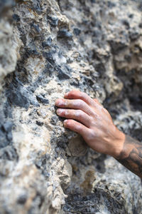 Human hand on rock