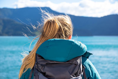 Rear view of woman in standing by sea