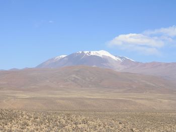 Scenic view of arid landscape against sky