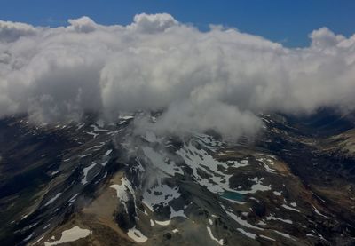 Scenic view of mountains against cloudy sky