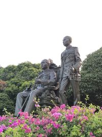 Low angle view of statue against trees