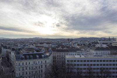 Cityscape against cloudy sky