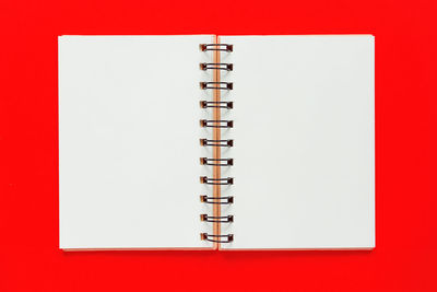High angle view of pen against red background