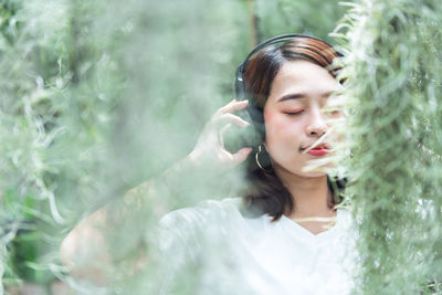 Portrait of a beautiful young woman with eyes closed