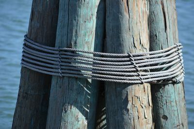 Close-up of rope tied on wooden post