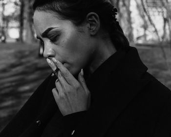 Woman looking away while smoking cigarette