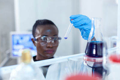 Portrait of scientist examining chemical in laboratory