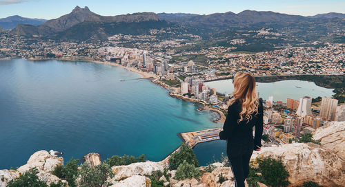 High angle view of woman standing by buildings in city