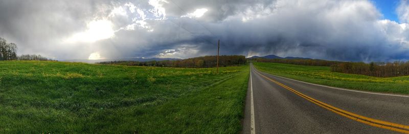 Country road passing through grassy field