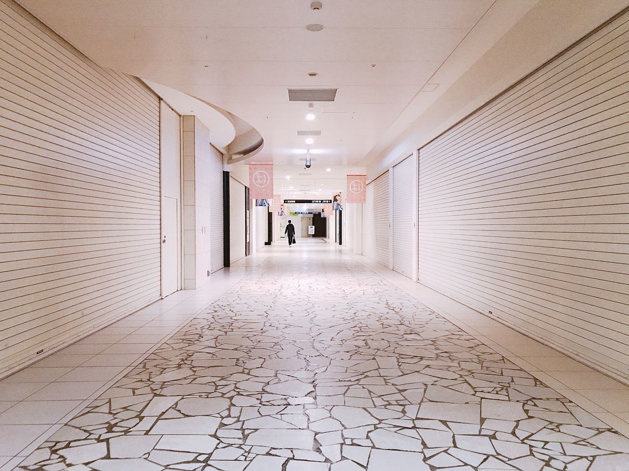 architecture, corridor, arcade, building, direction, indoors, built structure, flooring, the way forward, empty, ceiling, diminishing perspective, lighting equipment, tile, no people, illuminated, tiled floor, day, absence, architectural column, long