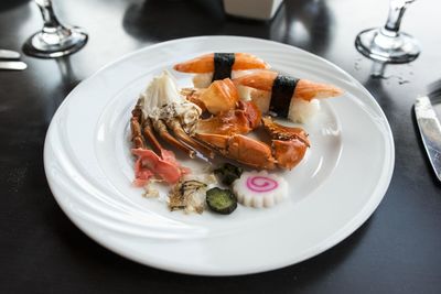Place setting with crab sticks in plate on dinner table