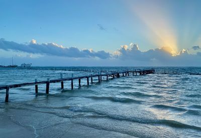 Pier over sea against sky