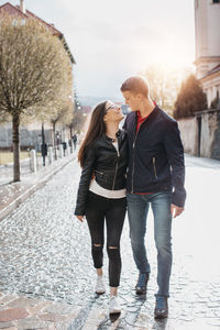 Full length of couple walking on footpath