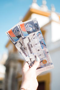 Close-up of woman holding tickets