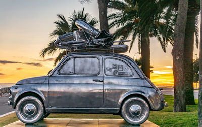 Vintage car on road during sunset