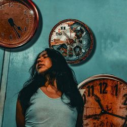 Portrait of woman standing against wall