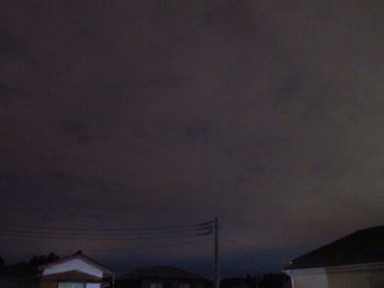 Low angle view of cables against sky at night