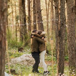 Full length of man standing by tree trunk in forest